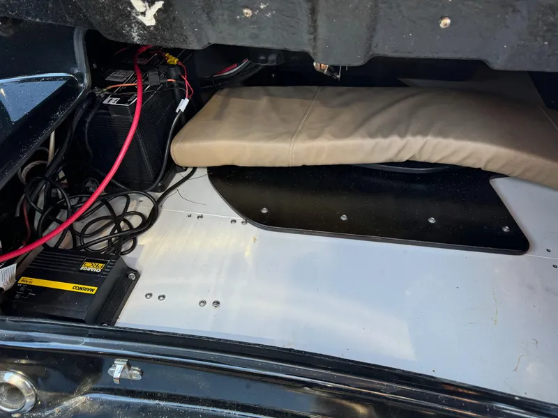 Slide: The Image of Interior view of a 2019 Brig Eagle 650 boat, showing battery and wiring setup. - 26