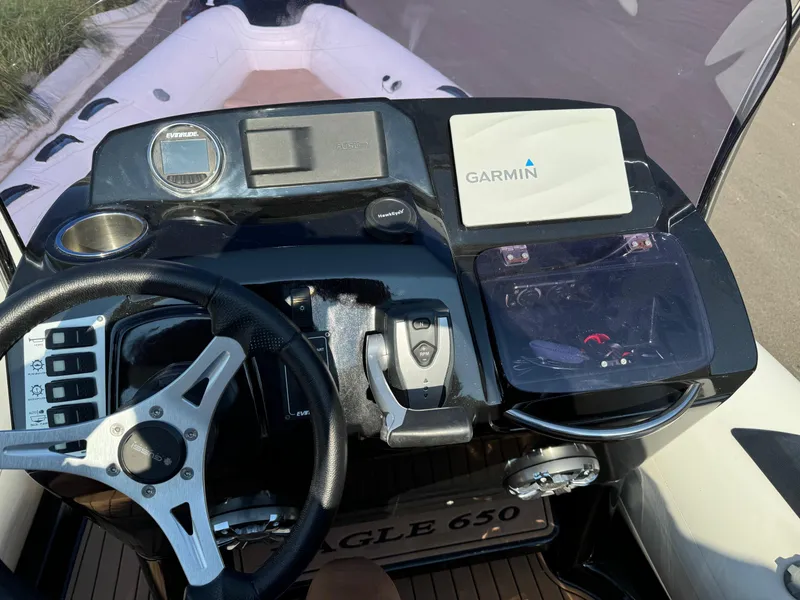 Slide: The Image of 2019 Brig Eagle 650 boat dashboard with Garmin navigation system and steering wheel. - 31