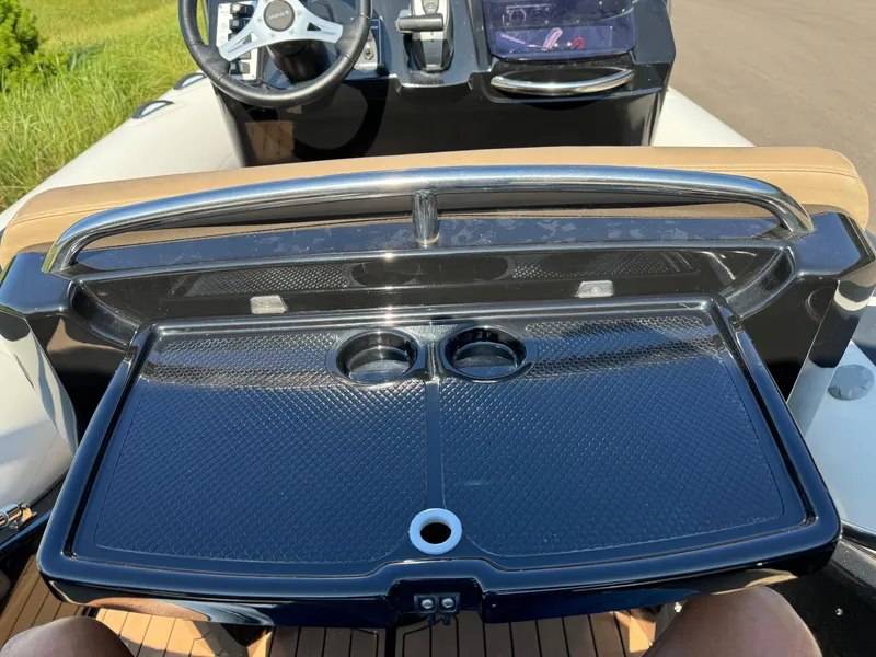 Slide: The Image of 2019 Brig Eagle 650 boat dashboard with steering wheel and cup holders. - 38