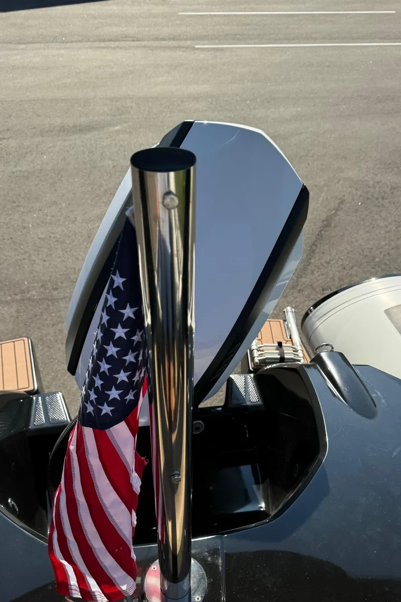 Slide: The Image of 2019 Brig Eagle 650 boat with American flag and paddle, parked on asphalt. - 45