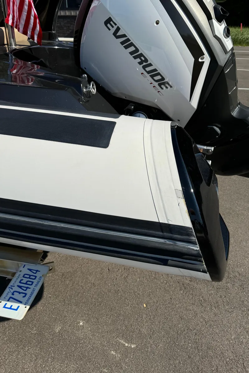 Slide: The Image of 2019 Brig Eagle 650 boat with Evinrude engine, parked on pavement. - 48