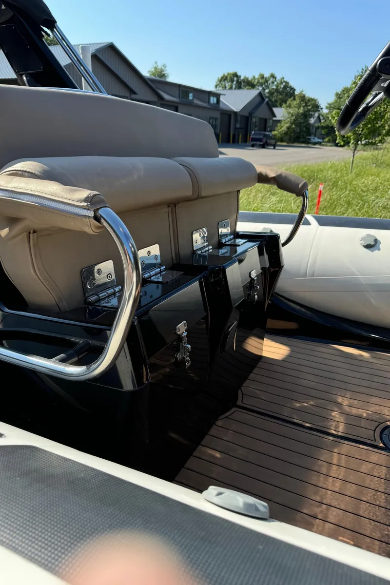 Slide: The Image of 2019 Brig Eagle 650 boat interior with beige seating and wooden deck. - 6