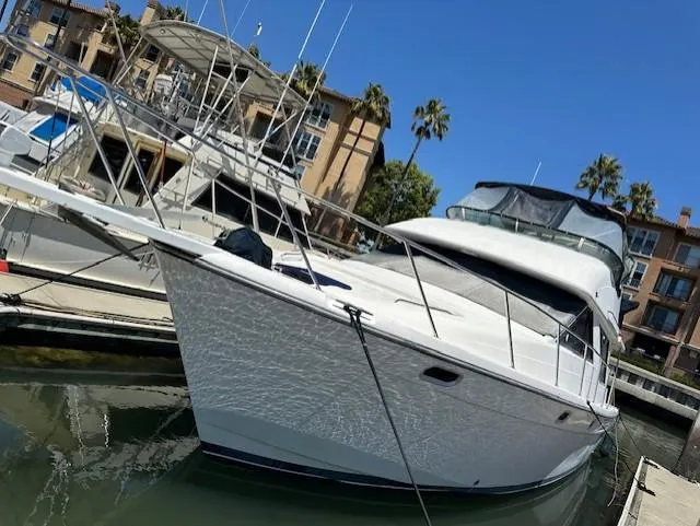 Slide: The Image of Bayliner 3988 Command Bridge Motoryacht 2002 docked at marina with clear blue sky. - 0