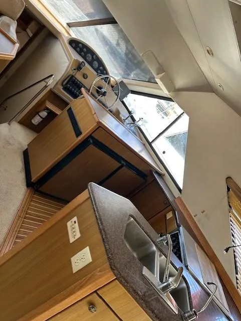 Slide: The Image of Interior of 2002 Bayliner 3988 Command Bridge Motoryacht with helm and kitchen area. - 11