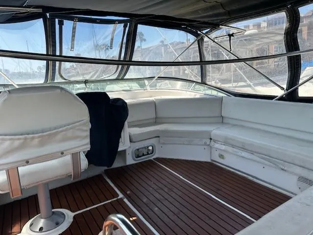 Slide: The Image of 2002 Bayliner 3988 Command Bridge Motoryacht interior with white seating and wooden flooring. - 14