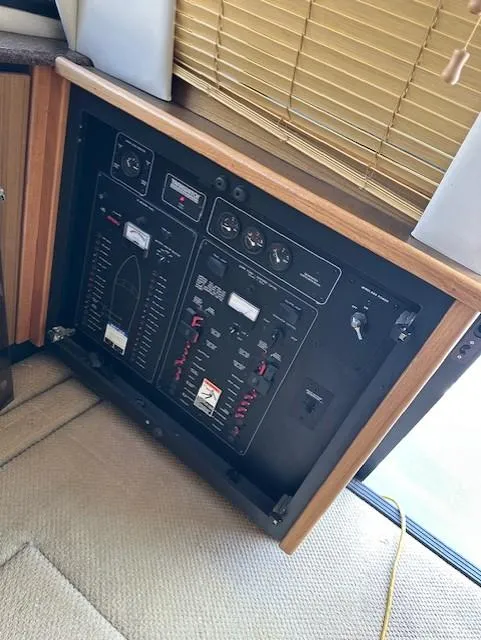 Slide: The Image of Electrical panel inside a 2002 Bayliner 3988 Command Bridge Motoryacht, featuring various controls and switches. - 15
