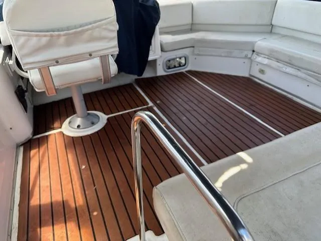 Slide: The Image of 2002 Bayliner 3988 Command Bridge Motoryacht interior with wooden deck and white seating. - 16