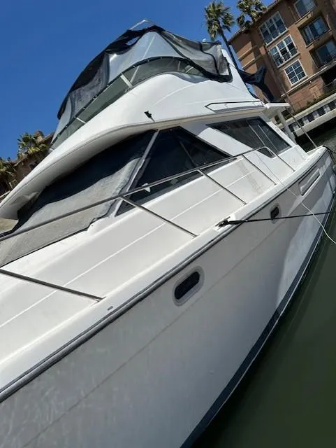 Slide: The Image of 2002 Bayliner 3988 Command Bridge Motoryacht docked near waterfront buildings. - 17