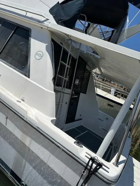 Slide: The Image of 2002 Bayliner 3988 Command Bridge Motoryacht, side view with ladder and deck details. - 18