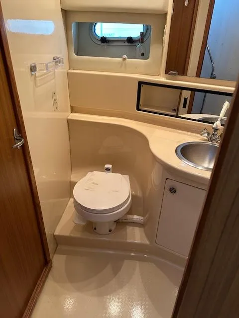 Slide: The Image of 2002 Bayliner 3988 Command Bridge Motoryacht bathroom with toilet, sink, and window. - 20