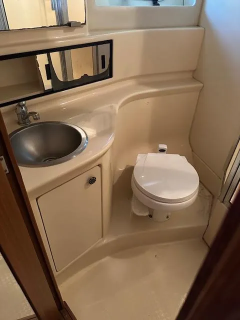 Slide: The Image of 2002 Bayliner 3988 Command Bridge Motoryacht bathroom with sink, toilet, and mirror. - 22