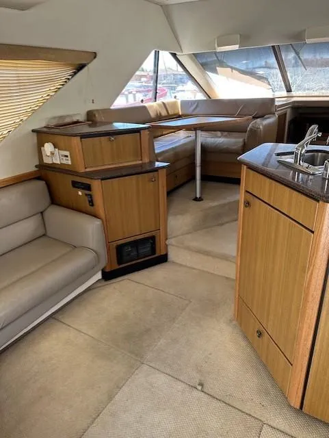 Slide: The Image of Interior of 2002 Bayliner 3988 Command Bridge Motoryacht with seating and kitchenette. - 3