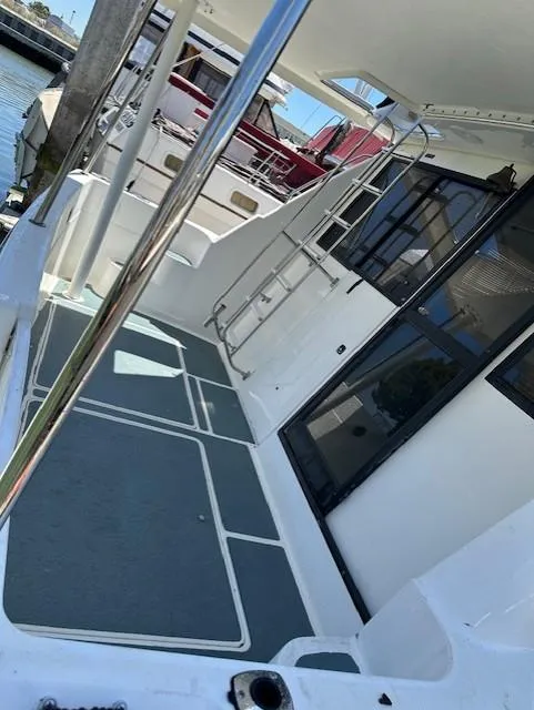 Slide: The Image of 2002 Bayliner 3988 Command Bridge Motoryacht deck with ladder and railing. - 5