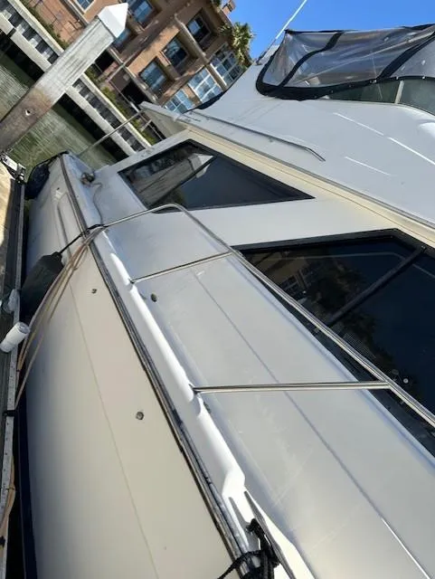 Slide: The Image of 2002 Bayliner 3988 Command Bridge Motoryacht docked at a marina, side view. - 7