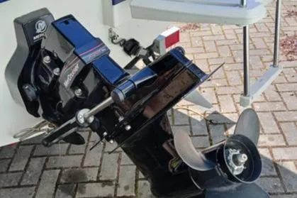 Slide: The Image of 2007 Bayliner 195 boat outboard motor on a paved surface. - 4