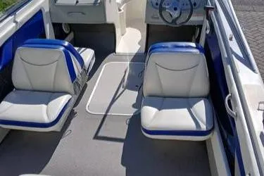 Slide: The Image of 2007 Bayliner 195 boat interior with blue and white seating and steering wheel. - 5