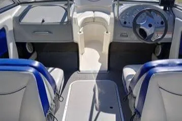 Slide: The Image of 2007 Bayliner 195 boat interior with steering wheel and seating. - 8