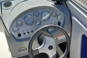 Slide: The Image of Dashboard of a 2007 Bayliner 195 boat with steering wheel and gauges. - 9