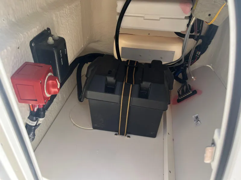 Slide: The Image of Battery compartment of 2025 Boston Whaler 150 Montauk with wiring and switch. - 14