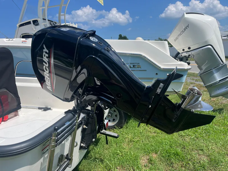 Slide: The Image of 2025 Boston Whaler 150 Montauk with Mercury outboard motor on grass. - 17