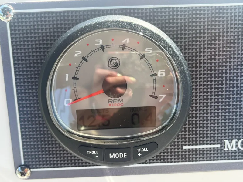 Slide: The Image of Close-up of a 2025 Boston Whaler 150 Montauk tachometer displaying RPM and voltage. - 2