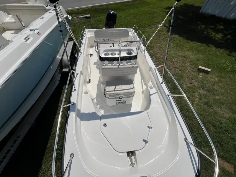 Slide: The Image of 2025 Boston Whaler 150 Montauk boat, top view, parked on grass. - 3