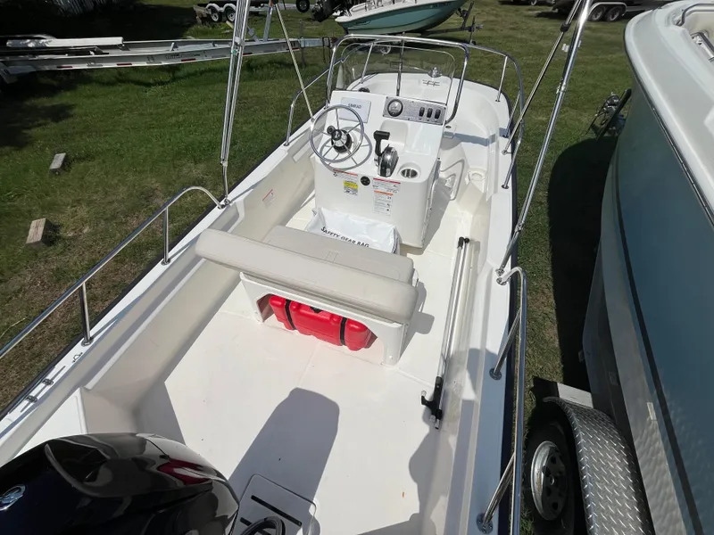 Slide: The Image of 2025 Boston Whaler 150 Montauk boat interior with steering console and seating. - 4
