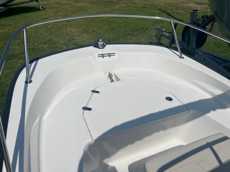 Slide: The Image of 2025 Boston Whaler 150 Montauk boat deck, featuring sleek design and stainless steel railing. - 7