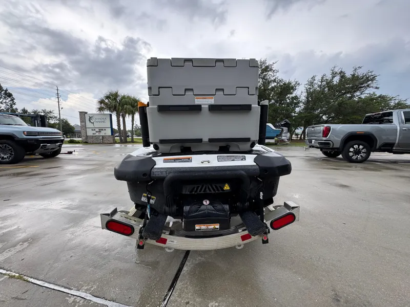 Slide: The Image of 2022 Sea-Doo Fish Pro Scout on trailer, parked in lot with overcast sky. - 10