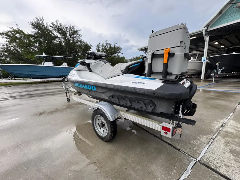 Slide: The Image of 2022 Sea-Doo Fish Pro Scout on trailer, parked outdoors near boats. - 12