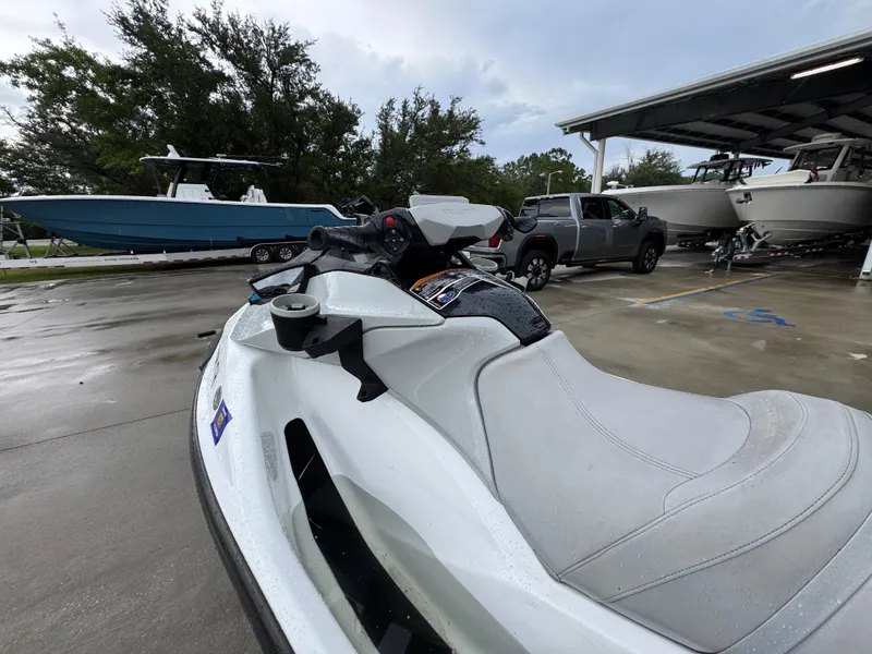 Slide: The Image of 2022 Sea-Doo Fish Pro Scout parked near boats and a truck. - 13