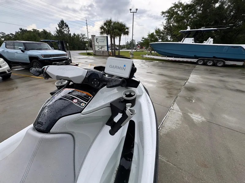 Slide: The Image of 2022 Sea-Doo Fish Pro Scout with Garmin GPS, parked near a boat and vehicles. - 15