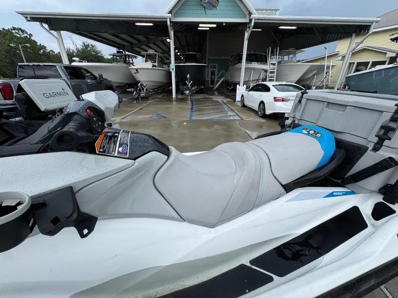 Slide: The Image of 2022 Sea-Doo Fish Pro Scout parked near boats and vehicles under a shelter. - 17