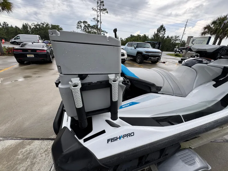 Slide: The Image of 2022 Sea-Doo Fish Pro Scout with fishing gear, parked in a lot on a rainy day. - 20