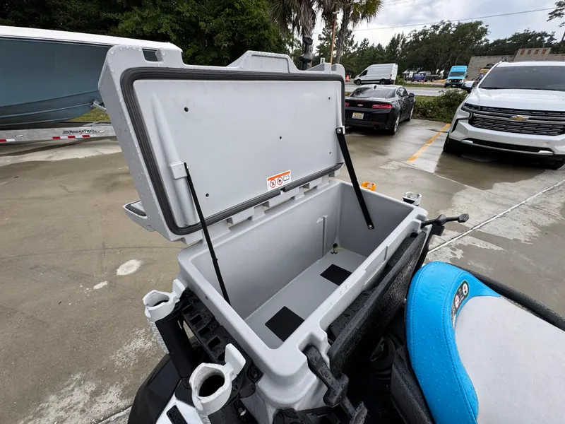 Slide: The Image of Open storage compartment on a 2022 Sea-Doo Fish Pro Scout, parked outdoors. - 21