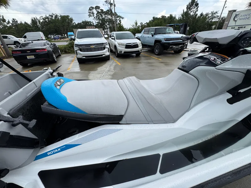 Slide: The Image of 2022 Sea-Doo Fish Pro Scout jet ski parked in a lot, showcasing its sleek design. - 22
