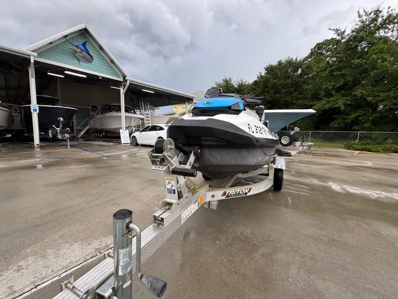 Slide: The Image of 2022 Sea-Doo Fish Pro Scout on trailer at marina, overcast sky. - 4