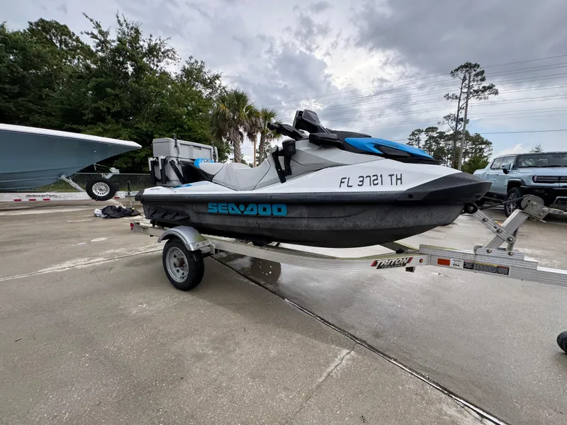 Slide: The Image of 2022 Sea-Doo Fish Pro Scout on trailer in parking lot, surrounded by cars and boats. - 5