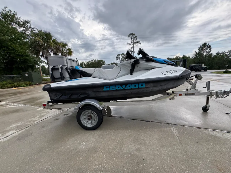 Slide: The Image of 2022 Sea-Doo Fish Pro Scout on trailer, parked outdoors under cloudy sky. - 6
