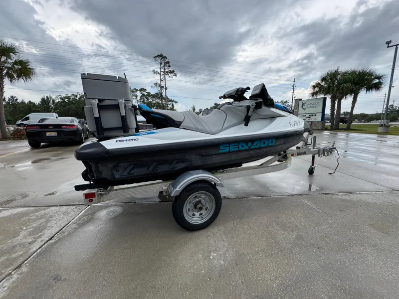 Slide: The Image of 2022 Sea-Doo Fish Pro Scout on trailer, parked outdoors under cloudy sky. - 7