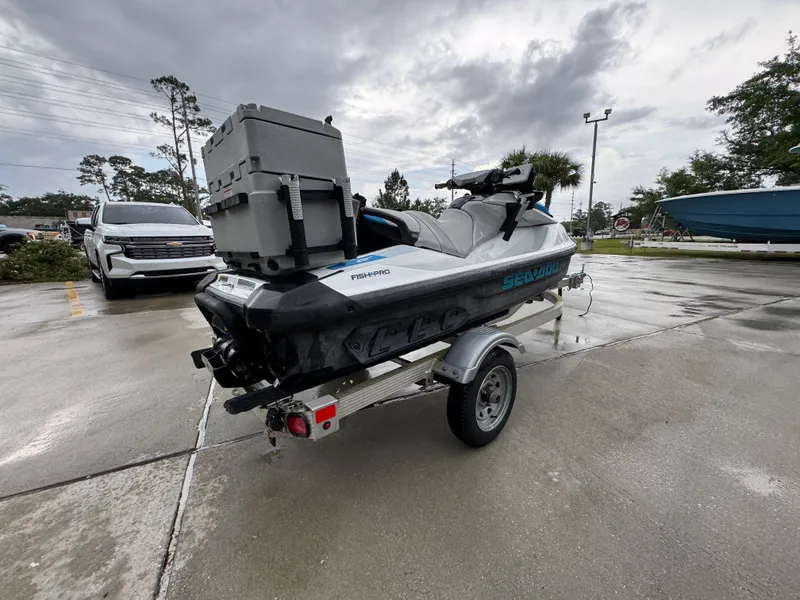 Slide: The Image of 2022 Sea-Doo Fish Pro Scout on trailer, parked outdoors on a cloudy day. - 8