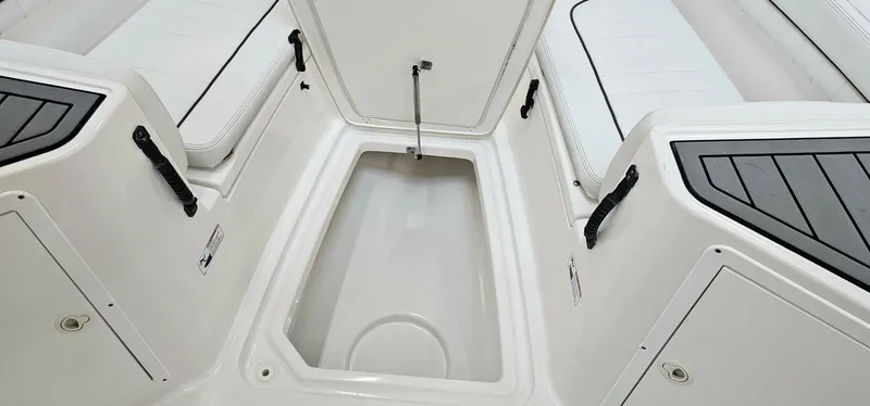 Slide: The Image of 2018 Yamaha Boats 210 FSH Deluxe interior storage compartment with seating. - 13