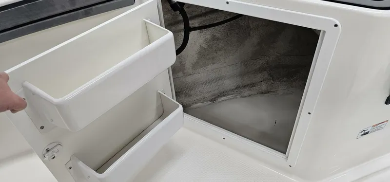 Slide: The Image of Open storage compartment on 2018 Yamaha Boats 210 FSH Deluxe. - 14