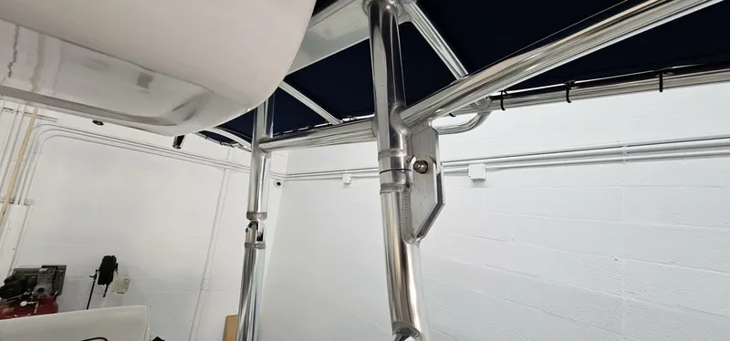 Slide: The Image of 2018 Yamaha Boats 210 FSH Deluxe, interior view with metal framework and canopy. - 18