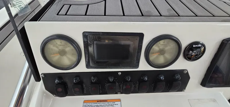 Slide: The Image of Control panel of 2018 Yamaha Boats 210 FSH Deluxe with gauges and switches. - 31