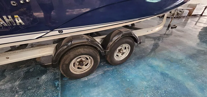 Slide: The Image of 2018 Yamaha Boats 210 FSH Deluxe on trailer, showcasing dual wheels. - 46