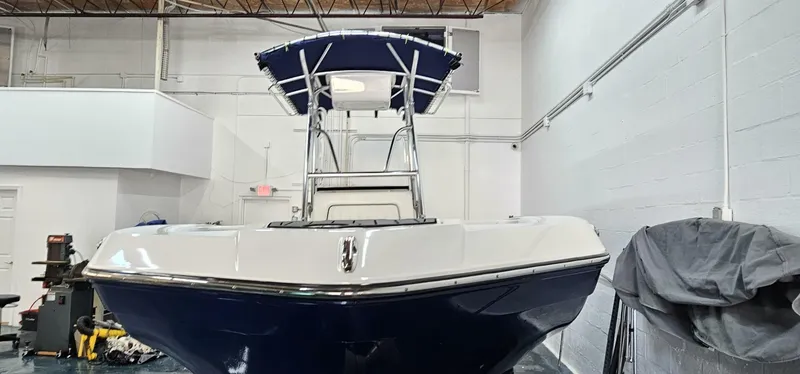Slide: The Image of 2018 Yamaha Boats 210 FSH Deluxe in indoor storage, front view. - 7