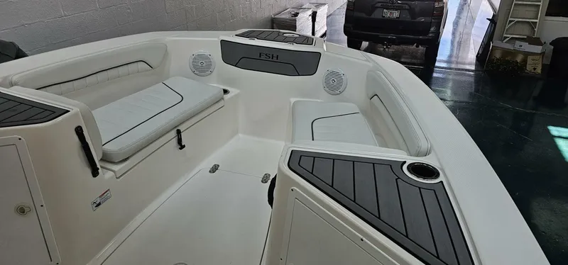Slide: The Image of 2018 Yamaha Boats 210 FSH Deluxe interior with seating and storage compartments. - 8