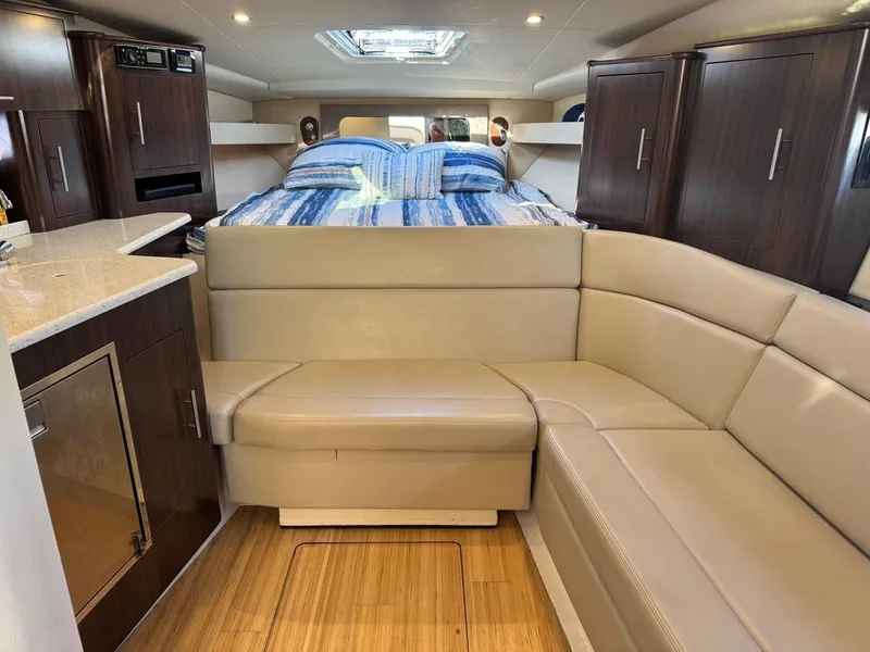 Slide: The Image of Interior of 2016 Regal 35 Sport Coupe with cozy seating and modern cabinetry. - 10