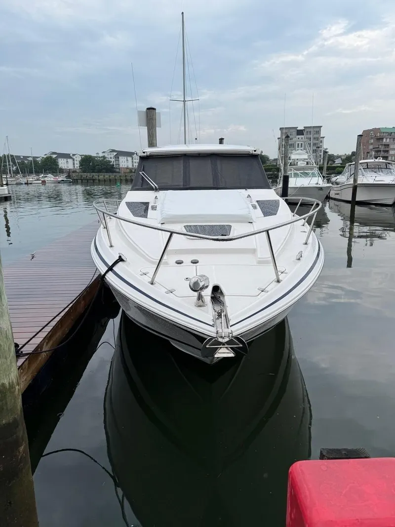 Slide: The Image of 2016 Regal 35 Sport Coupe docked at marina, overcast sky. - 2